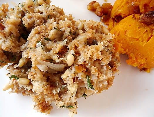 A serving of bread stuffing on a white plate.