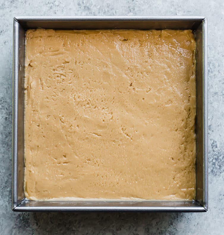 Peanut butter fudge spread into a pan.