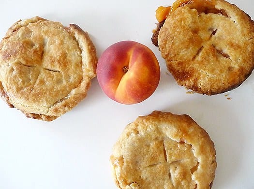 Overhead image of 3 peach pie tartlets after baking.