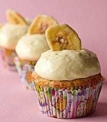 Banana cupcakes topped with vanilla pastry cream and a banana chip.