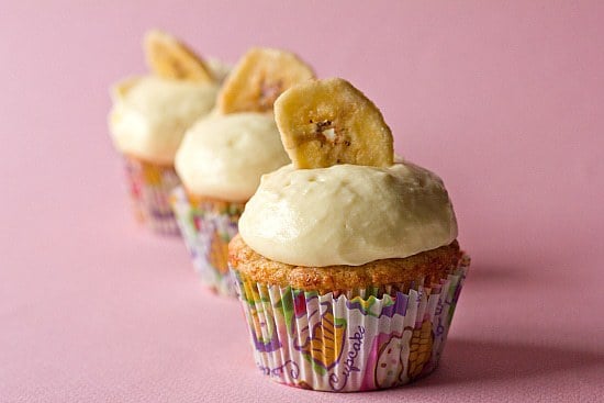 3 banana cupcakes topped with vanilla pastry cream and a banana chip.