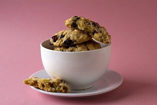 Cranberry white chocolate chip cookies in a white bowl.