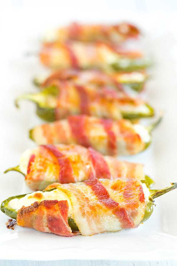 Jalapeno Poppers - A classic! Just three ingredients and super easy - halved, seeded jalapeños are stuffed with cream cheese and wrapped with bacon.