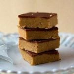 Stack of 4 peanut butter cup bars on a white plate.