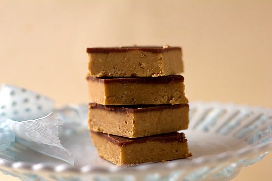 Stack of 4 peanut butter cup bars on a white plate.