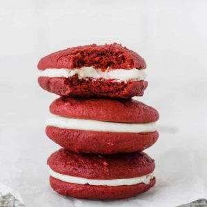 A stack of three red velvet whoopie pies.