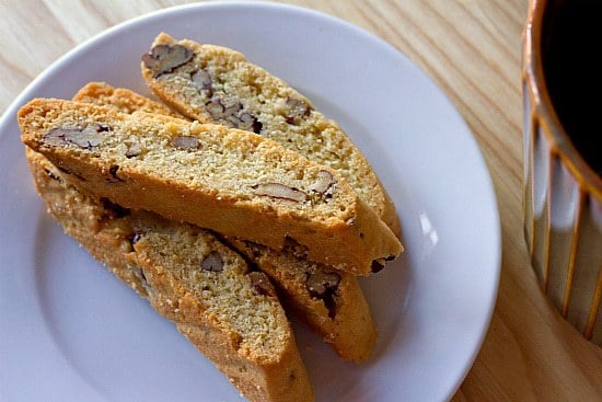 Overhead image of 4 pieces of anisette biscotti on a white plate.