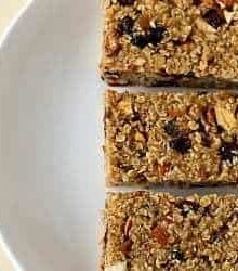 Overhead image of 3 homemade granola bars on a white plate.