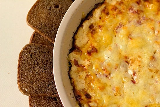 Overhead image of baked reuben dip in a white baking dish with crackers surrounding the dip.
