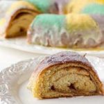 Slice of king cake on a white plate.