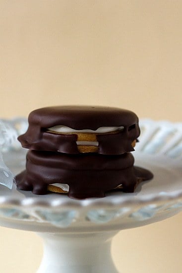 Stack of 2 moon pies on a white dessert stand.