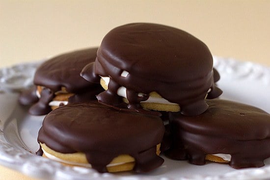 Pile of 4 moon pies on a white plate.
