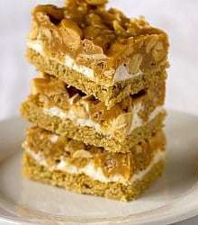 Stack of 3 salted peanut chew bars on a white plate.