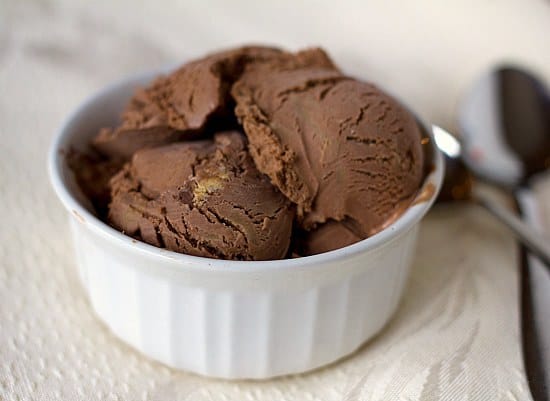 Scoops of chocolate peanut butter cup ice cream in a white bowl.