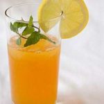 Ginger tea lemonade in a glass garnished with a lemon round.