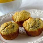3 lemon poppy seed muffins on a white plate.