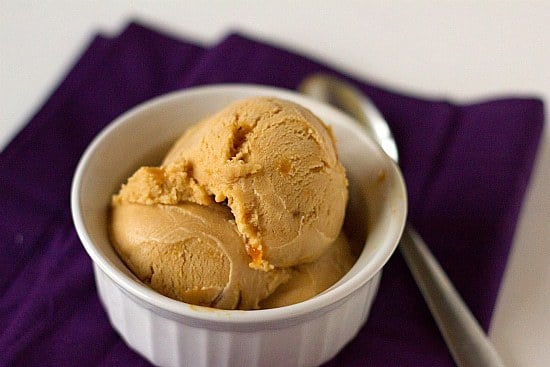 Scoops of salted caramel ice cream in a white bowl.