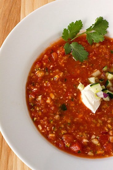 Overhead image of gazpacho in a white bowl.