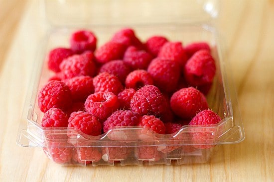 Fresh raspberries in a plastic carton.