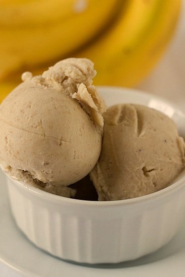 Scoops of roasted banana ice cream in a white bowl.