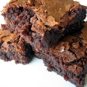 3 chocolate brownies on a white plate.