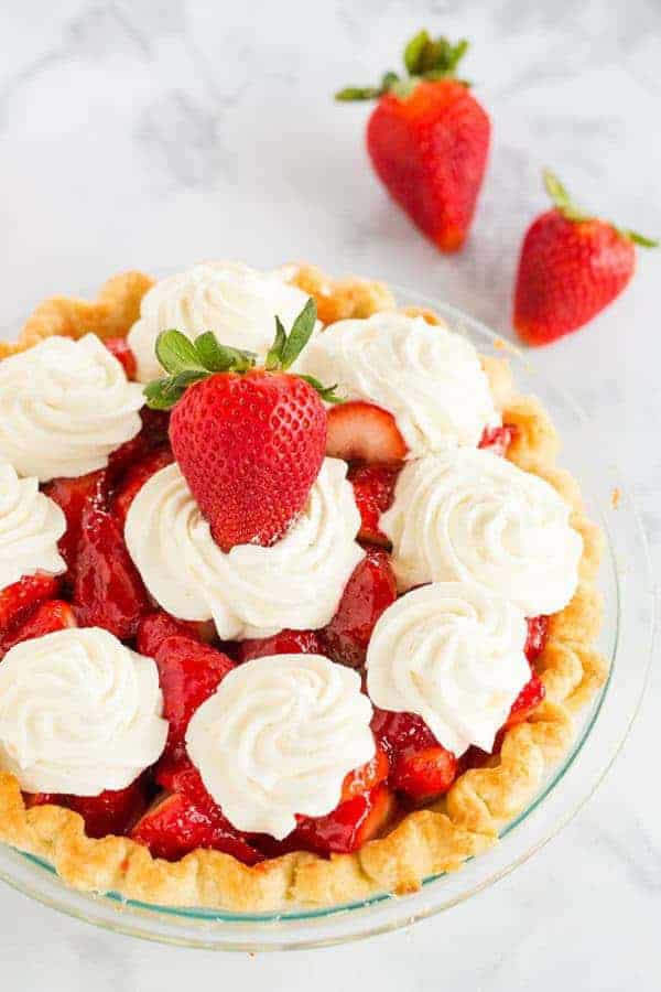 Strawberry Pie - This fresh strawberry pie is 100% homemade from my favorite crust, a delicious glaze, and sweet whipped cream. A perfect summer dessert!