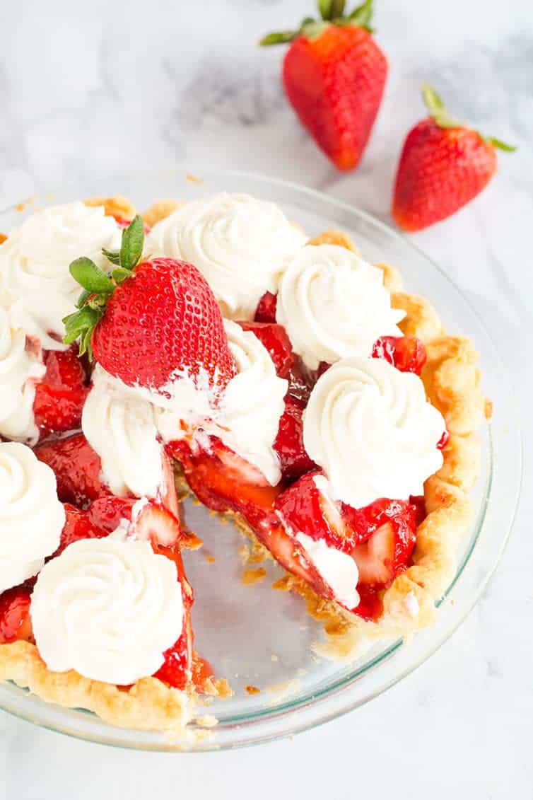 Strawberry Pie - This fresh strawberry pie is 100% homemade from my favorite crust, a delicious glaze, and sweet whipped cream. A perfect summer dessert!