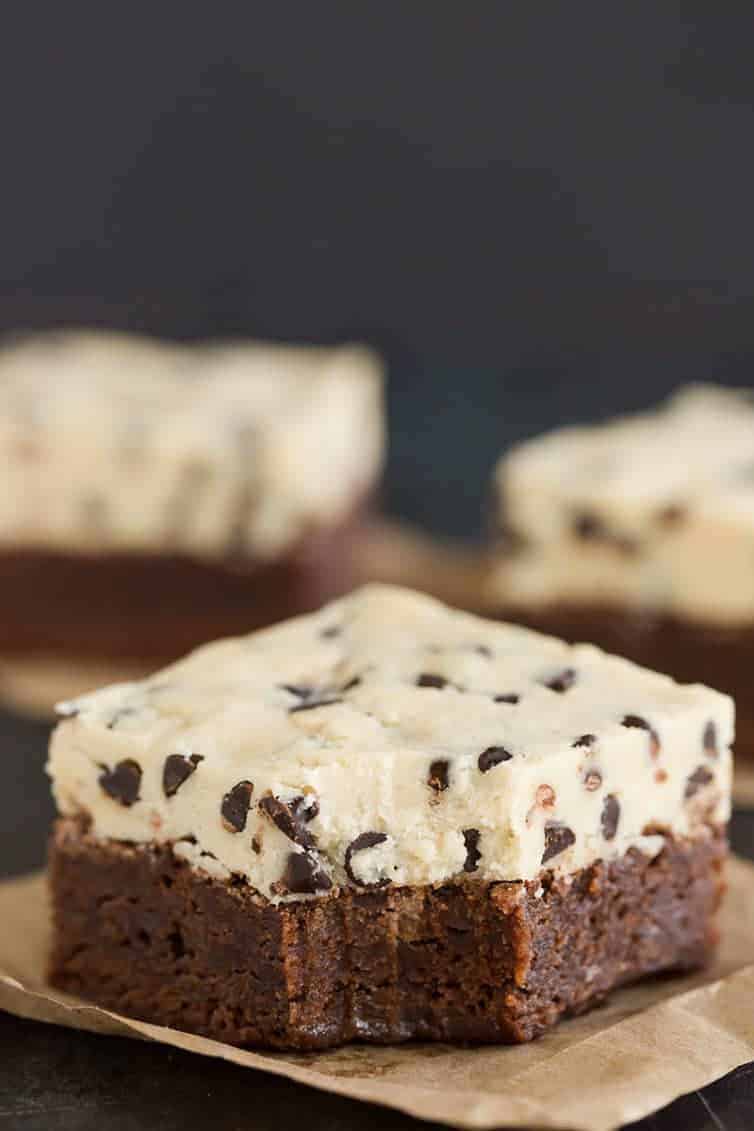 A chocolate chip cookie dough brownie with a bite taken out.