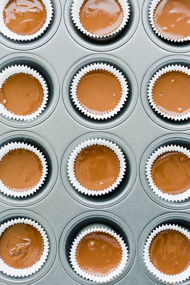 An overhead shot of peanut butter cups assembled and ready to be chilled.