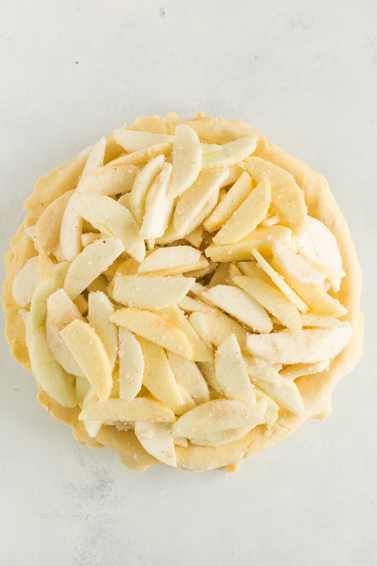 Apple pie filling inside a pie crust.