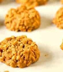 No bake peanut butter butterscotch cookies on a parchment paper lined baking sheet.