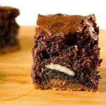 Chocolate chip cookie and Oreo brownie on a wood board.