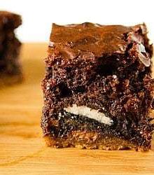 Chocolate chip cookie and Oreo brownie on a wood board.
