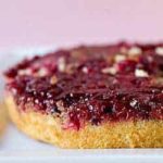 Cranberry upside down cake on a white serving tray.