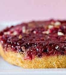 Cranberry upside down cake on a white serving tray.