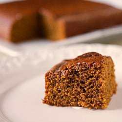 Slice of gingerbread cake on a white plate.