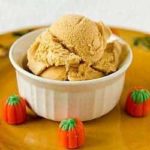 Scoops of pumpkin ice cream in a white bowl.