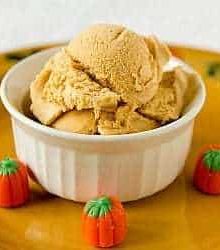 Scoops of pumpkin ice cream in a white bowl.