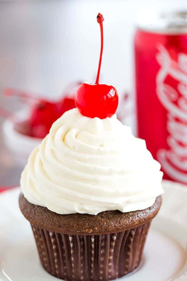 Cherry Coke Float Cupcakes - Chocolate cupcakes made with Coca-Cola, filled with cherries, topped with a Coca-Cola glaze, a whipped cream frosting and cherry on top!