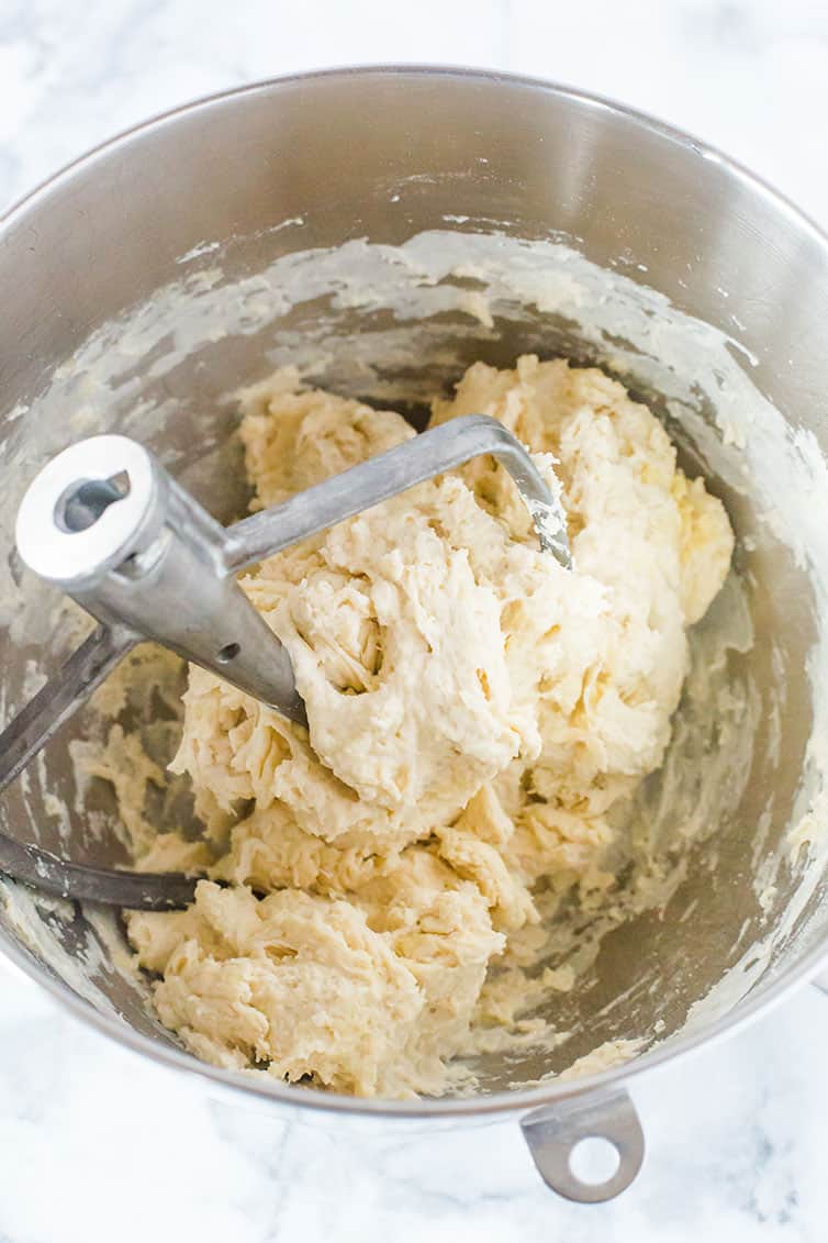 Focaccia bread dough in the bowl of a mixer.