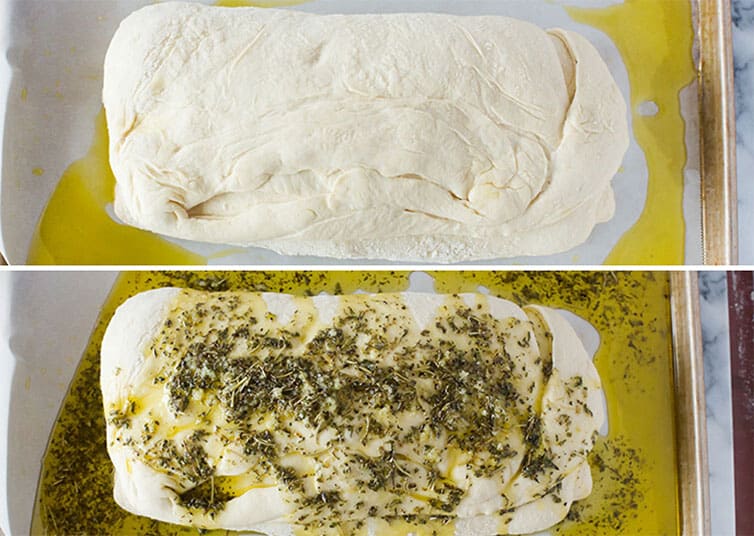 Focaccia dough covered in herb oil mixture.