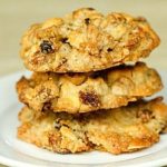 Stack of 3 granola cookies on a white plate.