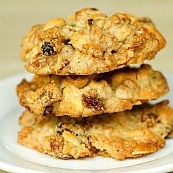 Stack of 3 granola cookies on a white plate.