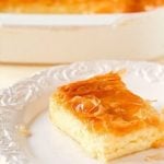 Square of Greek custard pie on a white plate.