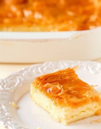 Square of Greek custard pie on a white plate.