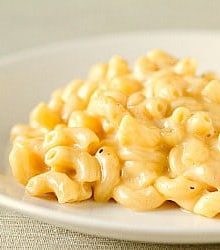 Serving of macaroni and cheese on a white plate.