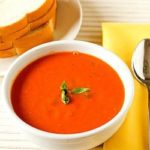 Tomato basil soup in a white bowl.
