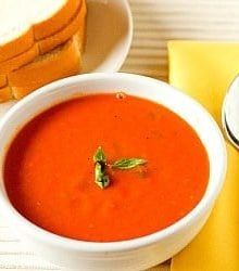 Tomato basil soup in a white bowl.