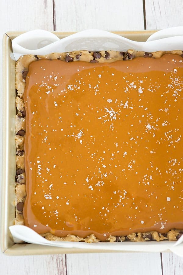 Salted Caramel Chocolate Chip Cookie Bars - A layer of salted caramel sauce is sandwiched between layers of a favorite chocolate chip cookie dough recipe, then topped with a sprinkle of fleur de sel.
