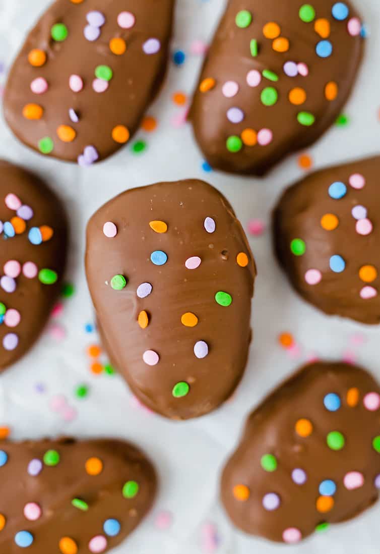 An overhead shot of peanut butter eggs, decorated with pastel sprinkles.